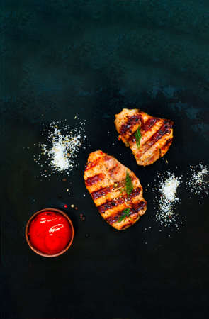 Grilled meat with spices on dark background. Close-up, copy spaceの写真素材