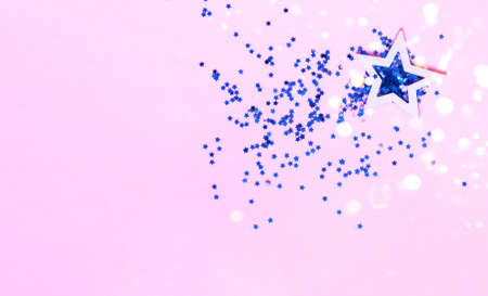 Decorative white star mit blue confetti on pink background. Design for wrapping paper or for giftsの写真素材