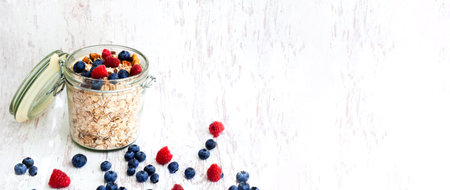 Muesli with blueberries in glass jar on wooden background. The concept of healthy breakfast or World...