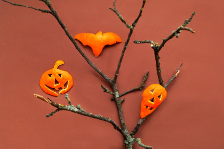 Funny orange figurines for Halloween on beige background. Holidays in the Time of COVID. Close-up, creative copy spaceの写真素材
