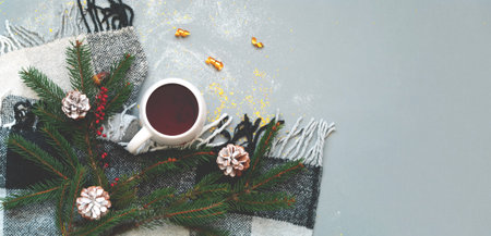 White cup with tea on gray background with sparkles. Hygge style for christmas or New Year. Minimal...