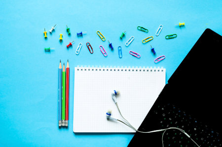 Laptop and Stationery supplies on blue background. Back to school or Distance learning in quarantine. Creative copy space. Close-upの写真素材