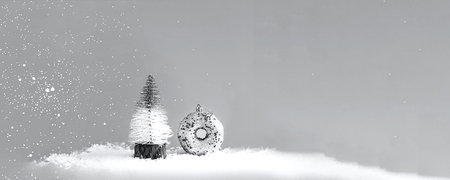 Decorative Christmas tree and silver donut on gray background with snow. Colors of the year 2021- Gray. Festive concept with blurred effect. Creative copy space. Close-upの写真素材