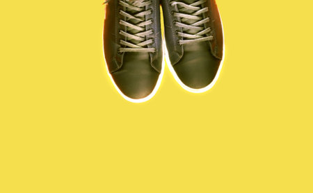 Gray sneakers on yellow mat. Sport concept. Trendy colors 2021. Creative copy space. Close-upの写真素材