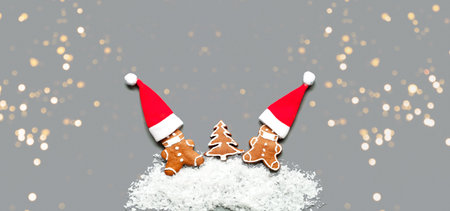 Gingerbread men in face mask from ginger biscuits on gray background. New Years decoration....