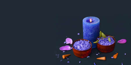 Spa composition with light candleson dark background. Wellness at home.の写真素材