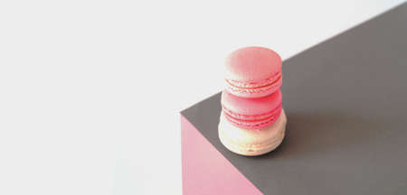 Pink macarons on geometric background. Trendy colors 2021. Creative copy spaceの写真素材