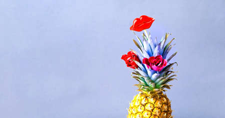 Colored pineapple with roses and red lips on stick.Creative festive background. July 6, World Kiss Day. Close-upの写真素材
