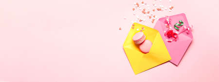 Colorful envelopes with pink macaroons and confetti. Festive concept or Romantic Love message....