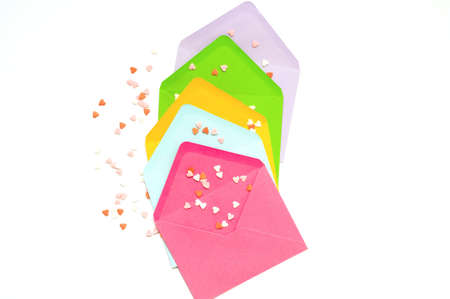 Colorful envelopes with christmas wooden figurines on white background. Christmas design. Creative...