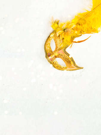 Carnival gold mask on white texture. Minimum composition. Festive mood. Creative copy space....