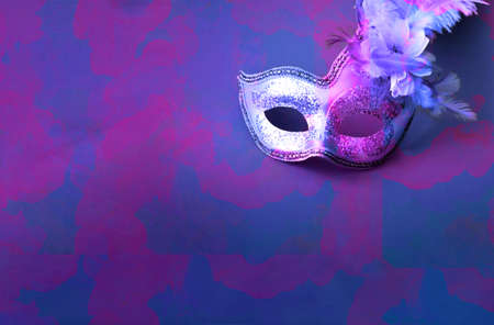 Carnival mask on abstract background with mixed alcohol ink paints. Design Trend: Psych Out. Trendy color.の写真素材