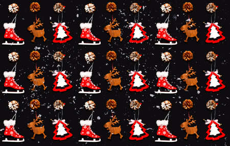 Pattern of Christmas wooden figurines on dark background. Festive concept for gift wrapping paper...