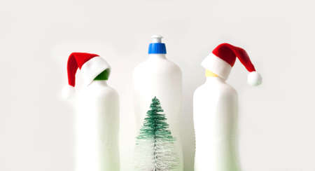 Means for cleaning and disinfection in white bottles with Christmas decorations. Festive light background for design. Close-upの写真素材
