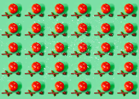 Ingredients for mulled wine. Organic apple and spices on green background. The concept of ecological products. Design for wrapping paper. Creative copy spaceの写真素材