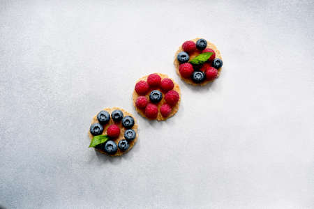 Berry-Topped Pizza or Italian mini waffles on light background. Summer Color Trends,...