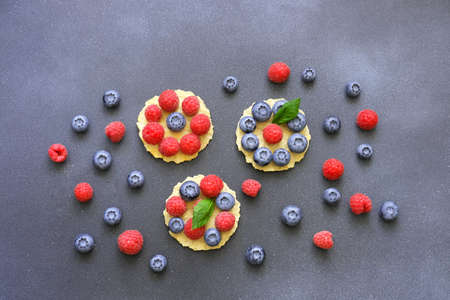 Berry-Topped Pizza or Italian mini waffles on dark background. Summer Color Trends, Attention-grabbing Palettes. Creative copy space. Close-upの写真素材