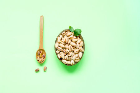 Organic ingredients in a coconut bowl for Flexitarianism or Flexible Vegetarianism on green background. Creative copy space. Close-upの写真素材