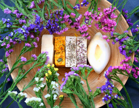 Handmade soap against the background of kermek flowers. Handmade organic soap concept from natural...