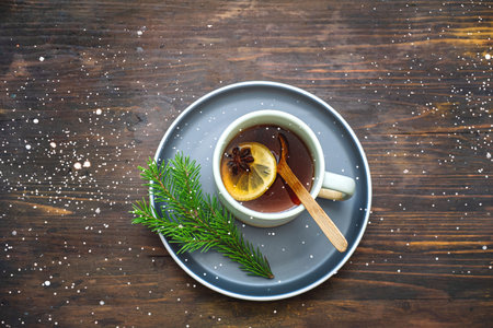 Ceramic cup with tea on a wooden background. Creative space for Christmas design. Close-upの写真素材