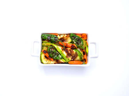 Baked or grilled vegetables on yellow background. Cooking delicious food at home.の写真素材