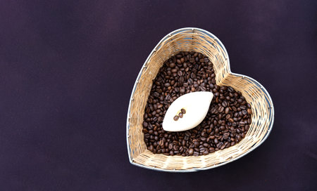 Handmade soap on the texture of coffee beans in straw basket made in the shape of heart. Caffeine...