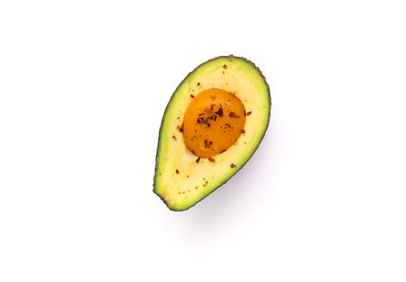 Baked egg yolk with avocado. Healthy and balanced products. Fodmap diet concept. Homemade food.