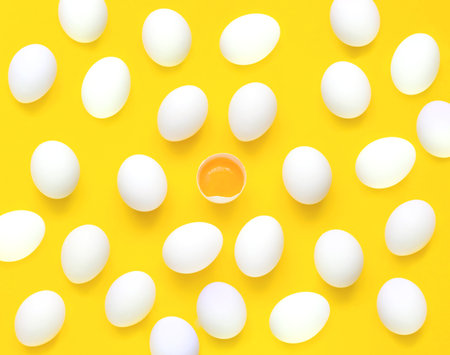 Pattern from chicken white eggs,yolk and half eggs iyellow background. Concept of foods rich in vitamin D. Diet product. Close-upの写真素材