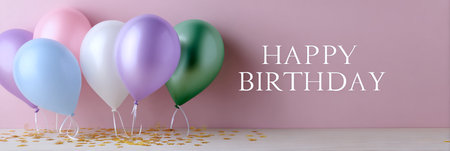 Colorful balloons with confetti and happy birthday greeting on a pink background.の素材