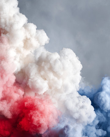Vibrant smoke clouds in red, white, and blue blend together against a soft gray backdrop, creating a dynamic visual effect suitable for artistic and creative usesの素材