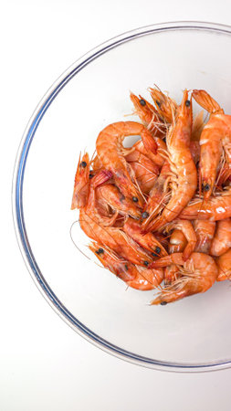 Small boiled shrimps in a deep glass bowl on a white backgroundの写真素材