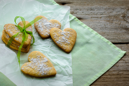 Homemade baked heart cookies tied with green ribbon. Gifts and holidays concept.の写真素材