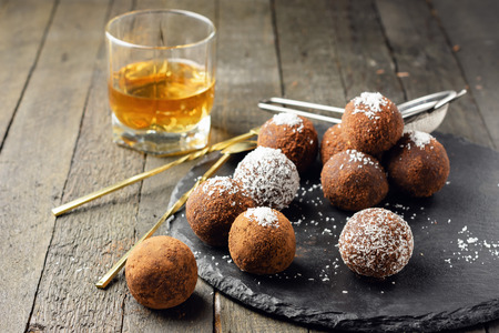 Chocolate rum truffles. Sweet dessert on a dark wooden background.の写真素材