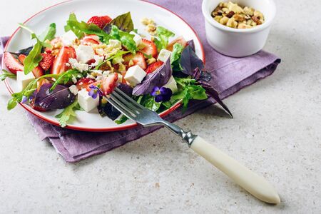 Salad with strawberries, arugula, basil and cheese.の写真素材