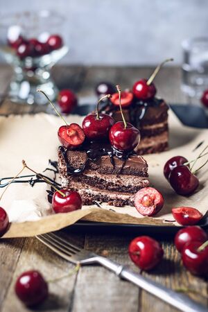 Chocolate cake with fresh cherries on a plate.の写真素材