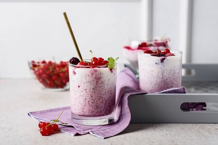 chia seed pudding with fresh red currants and raspberries.の写真素材