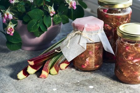 Organic jam with rhubarb and rose petals in jars.の写真素材