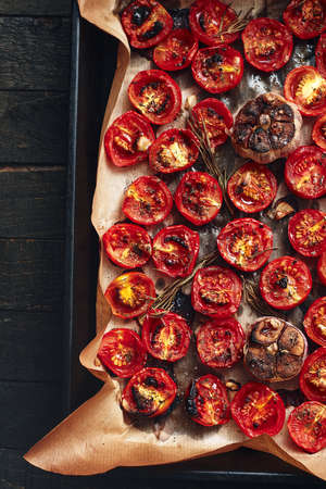 Oven roasted cherry tomatoes on an oven tray. Overhead view.の写真素材
