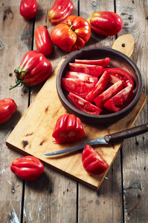 Fresh tomatoes for making tomato sauce on a wooden cutting board.の写真素材
