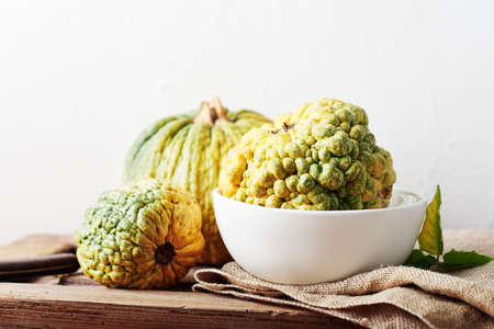 Yellow decorative pumpkins on a wooden table, autumn still life.の写真素材