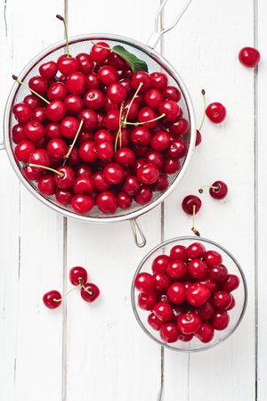 Fresh cherries on a white wooden background.の写真素材