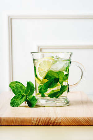 Cold mint tea with lemon and ice cubes.の写真素材