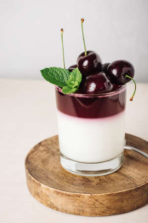 gelatin dessert. Yoghurt and cherry jelly on a light background.の写真素材