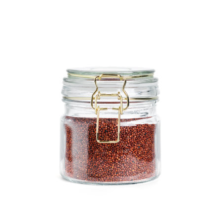 Glass jar of red quinoa isolated on white background.の写真素材
