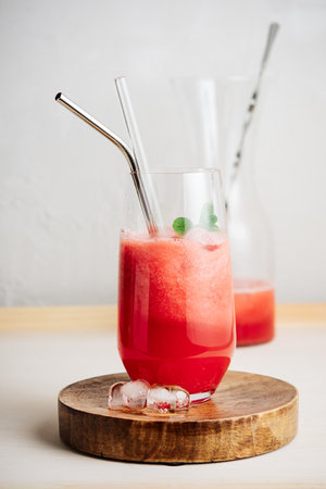 Refreshing watermelon Agua fresca drink in a glass with a straw.