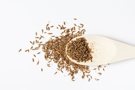 Cumin seeds or zira spice in a spoon on a white background.の写真素材