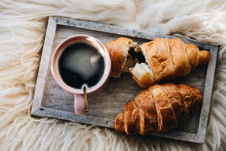 Cup of coffee with chocolate croissants on the tray.の写真素材