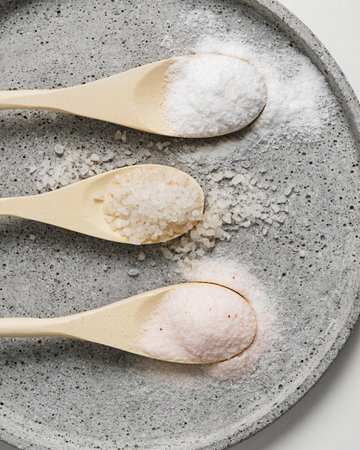 Three types of sea salt in wooden spoons.の写真素材