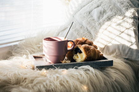 Cup of coffee with chocolate croissants on a windowsill.の写真素材