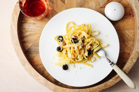 Tagliatelle pasta with tuna, olives and cheese.の写真素材